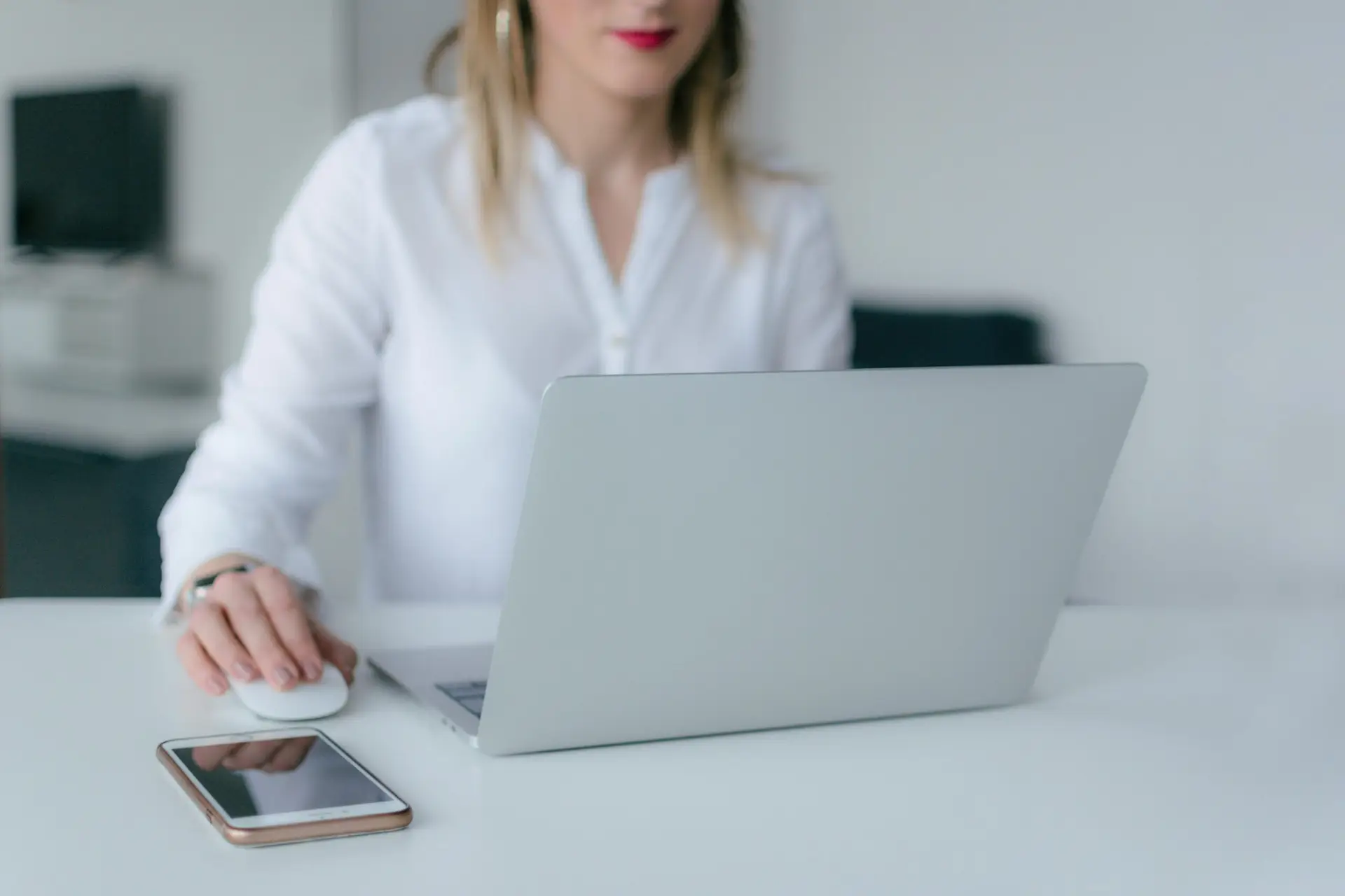 Business owner typing on a computer at an office.